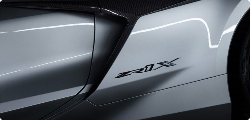 New Corvette ZR1X badge on 2026 Corvette ZR1X in Blade Silver Metallic. Preproduction model shown, actual production model may vary.