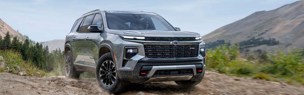 2026 Chevy Traverse driving on a rugged mountain trail