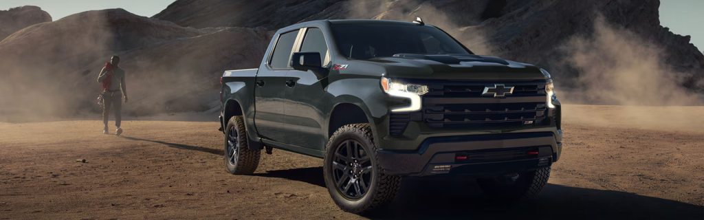 2026 Chevy Silverado 1500 parked in a rugged desert landscape, showcasing its off-road capability.